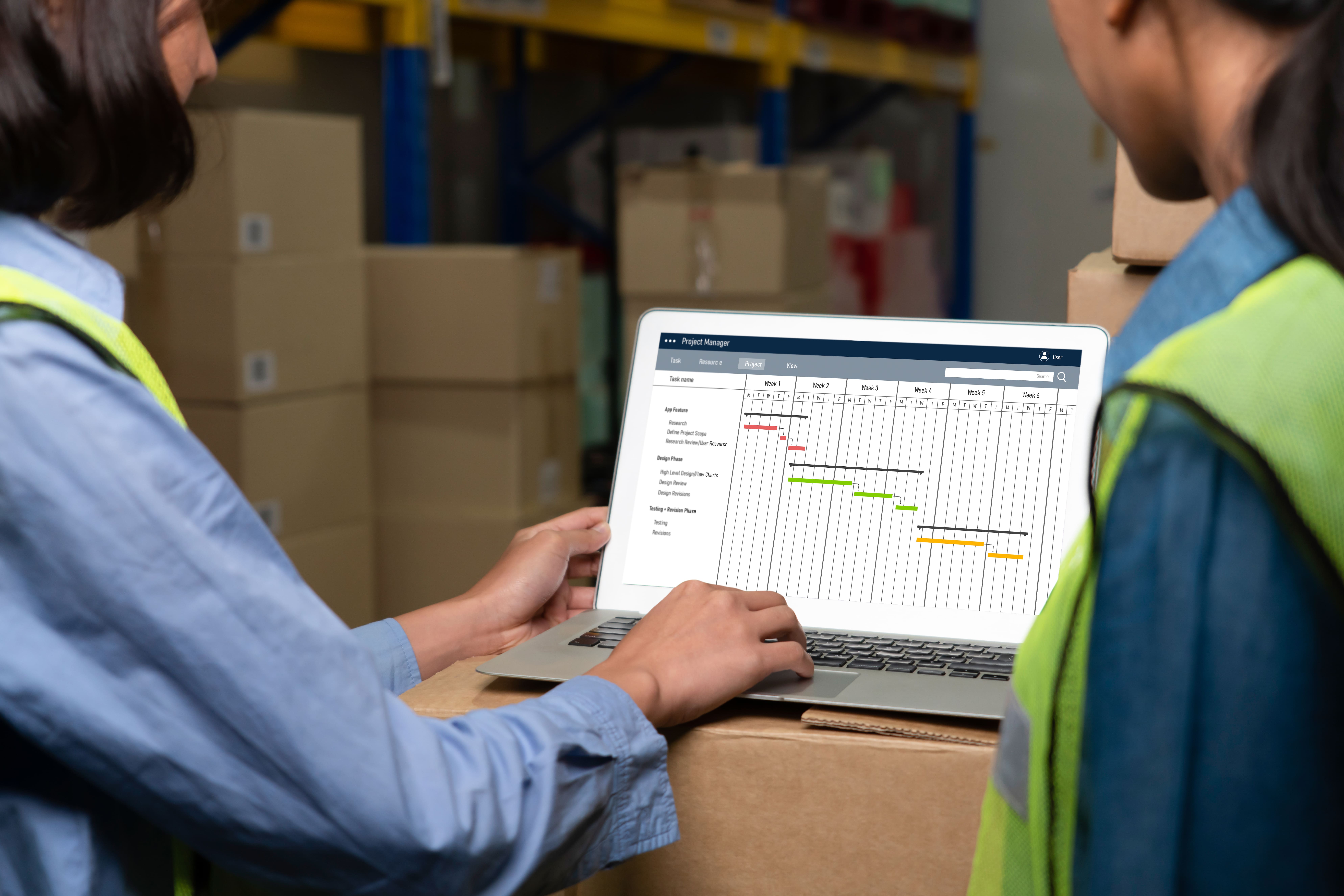 Team managing warehouse operations on a laptop — AI-powered custom business 					solution for stock control and logistics.